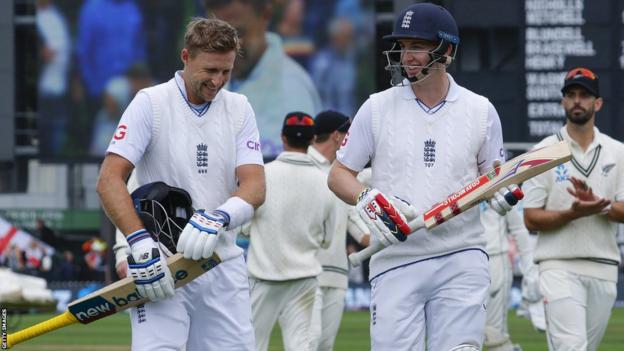 England batters Joe Root (left) and Harry Brook (right) walk off the pitch