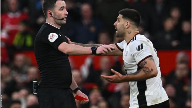 Aleksandar Mitrovic grabs referee Chris Kavanagh before being sent off during Fulham's FA Cup quarter-final defeat at Manchester United
