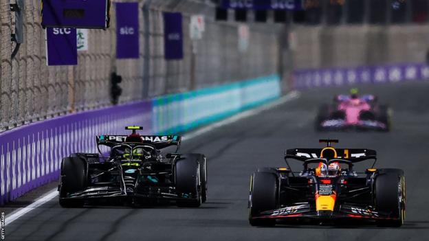 Lewis Hamilton driving alongside Max Verstappen
