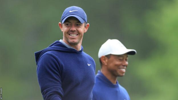 Rory McIlroy and Tiger Woods smile during a practice round at Augusta National before the Masters