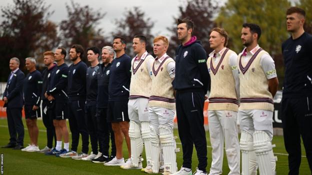 Somerset and Northants players line up for the national anthem at Taunton