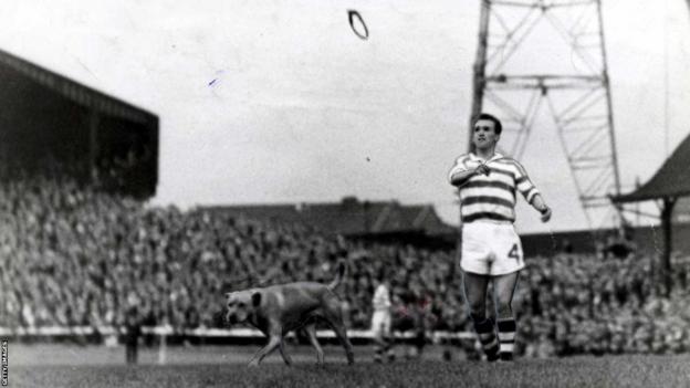 Paddy Crerand throws a toy for a dog while playing for Celtic at Aberdeen in 1963