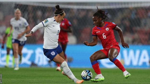 Melchie Dumornay (6) takes on England's Lucy Bronze