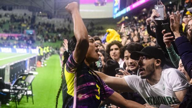 Colombia defender Daniella Arias celebrates with supporters at Melbourne Rectangular Stadium after they beat Jamaica