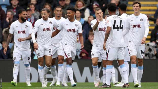 Aston Villa players celebrate a goal against Burnley at Turf Moor